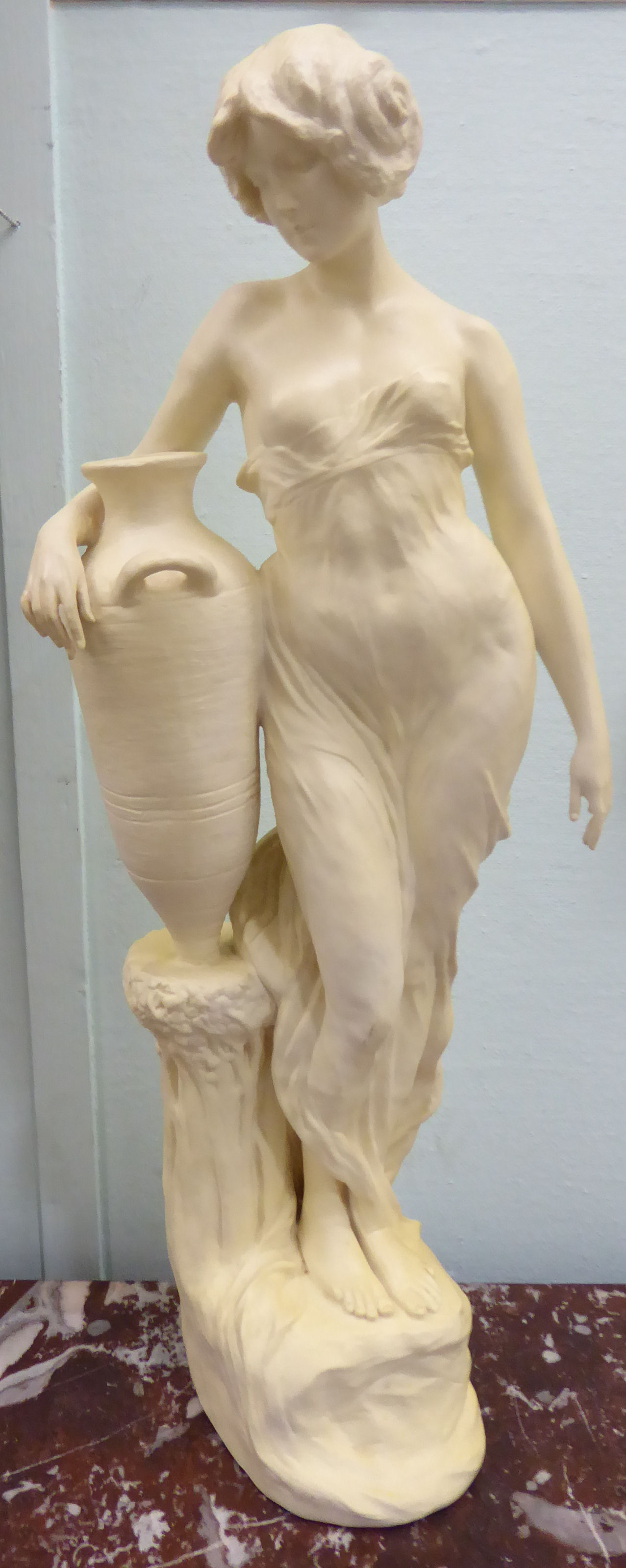 An unglazed standing plaster figure 'Aphrodite' holding a water vessel, - Image 2 of 16