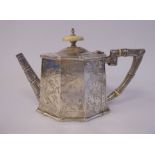 A late Victorian silver Orientally inspired teapot of elongated octagonal form with tapered sides,