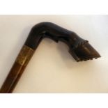 A late Victorian walking cane, the tapered shaft with a moulded and carved horn,