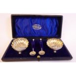 A pair of late Victorian silver scallop shell design salt cellars,
