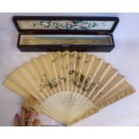 An early 20thC Japanese ivory fan with profusely floral carved guards,