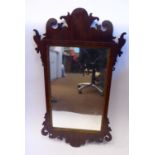 A late 19thC Chippendale inspired mirror, set in a fretworked,