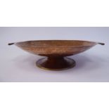 An Arts & Crafts inspired spot-hammered copper dish, the shallow bowl with opposing tab handles,