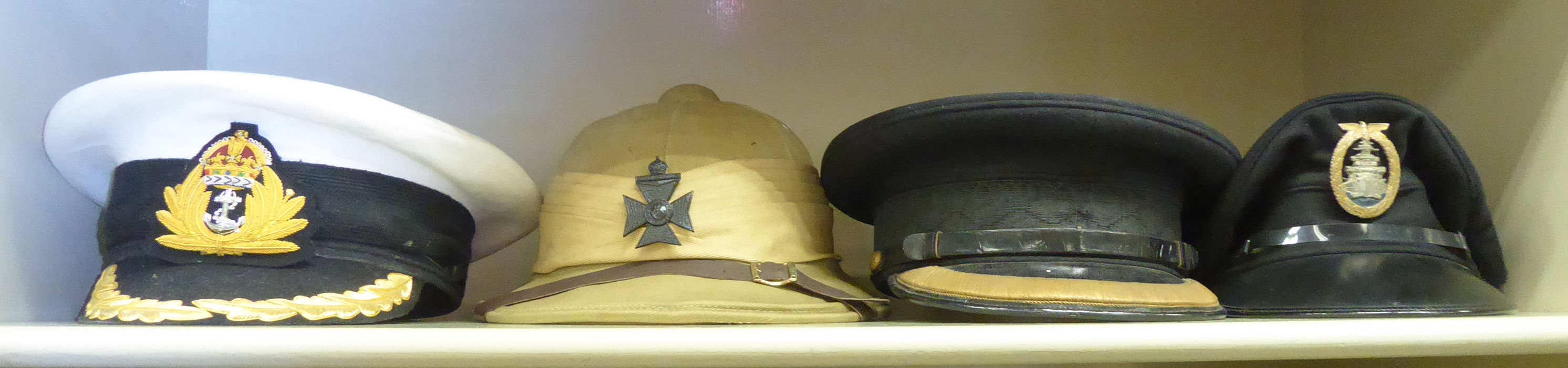 A khaki coloured, fabric covered pith helmet,