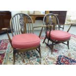 A pair of Ercol dark stained beech framed low,