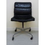 A Herman Miller chair with a cushioned black hide upholstered back and seat,