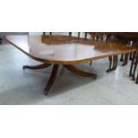A Regency inspired, walnut finished coffee table with a figured,