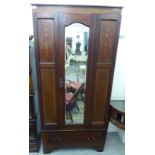 An Edwardian string inlaid mahogany wardrobe with a central bevelled mirror and marquetry panels,