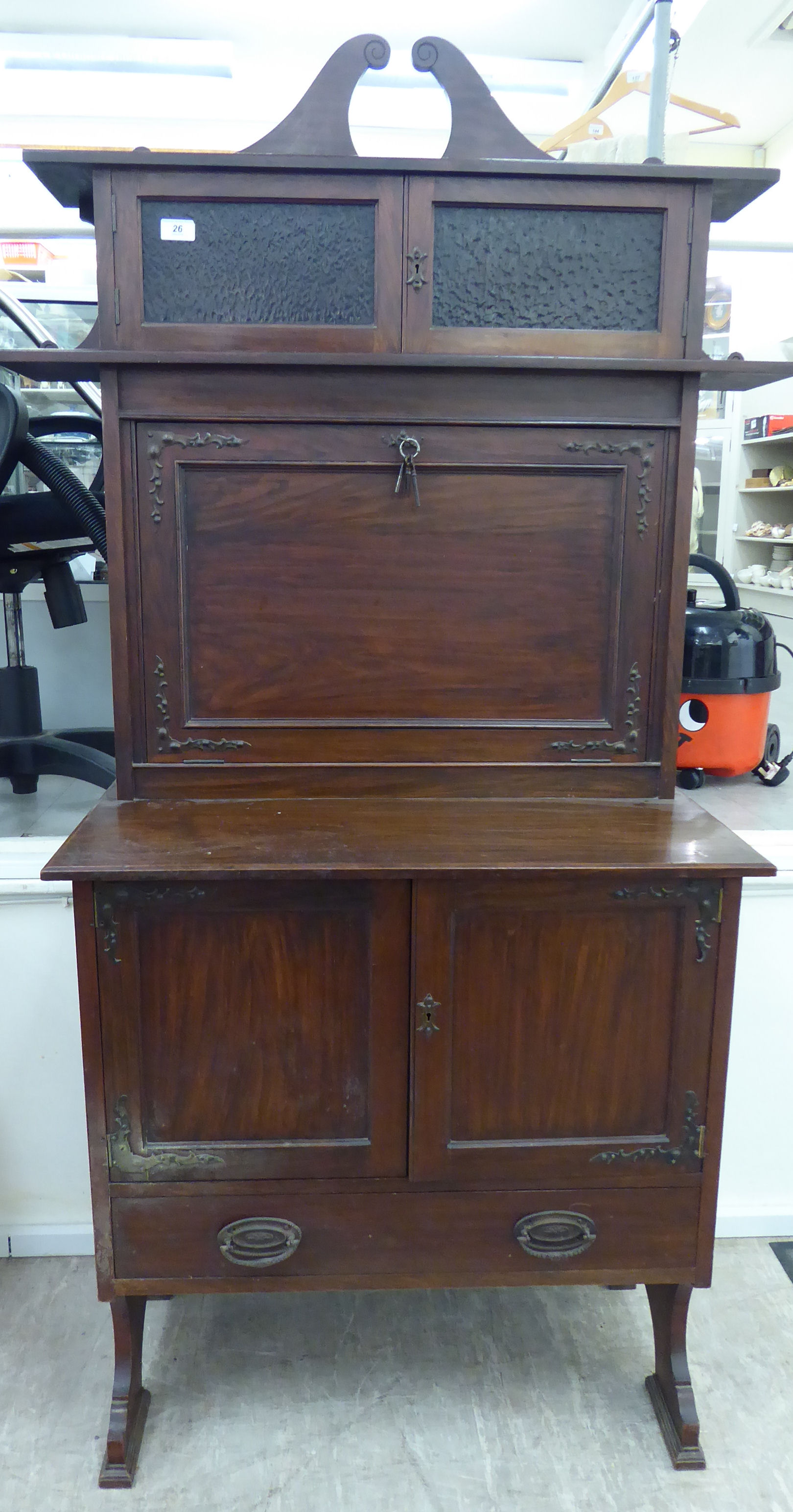 An early 20thC mahogany and faux rosewood desk,