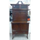 An early 20thC mahogany and faux rosewood desk,