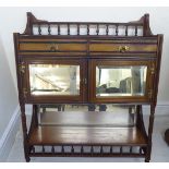 A late Victorian part ebonised mahogany hanging cabinet with spindled galleries and brass fittings,