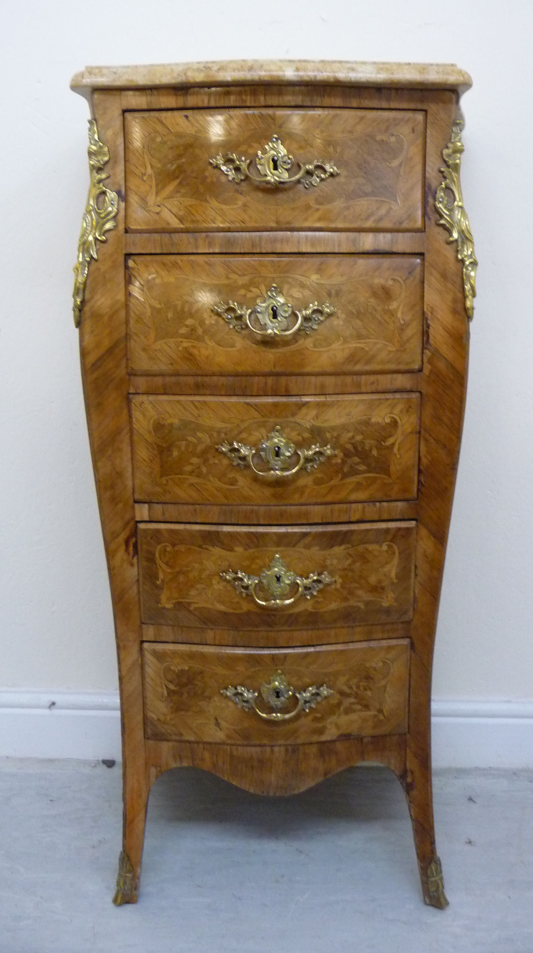 An early 20thC Louis XV inspired satinwood inlaid Kingwood veneered pedestal chest with a