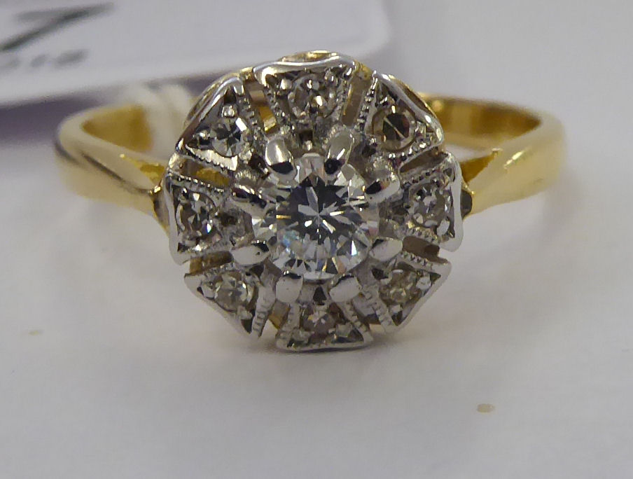 An 18ct gold diamond cluster ring 11