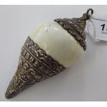 An Oriental white cowrie shell pendant with embossed and chased silver coloured metal mounts