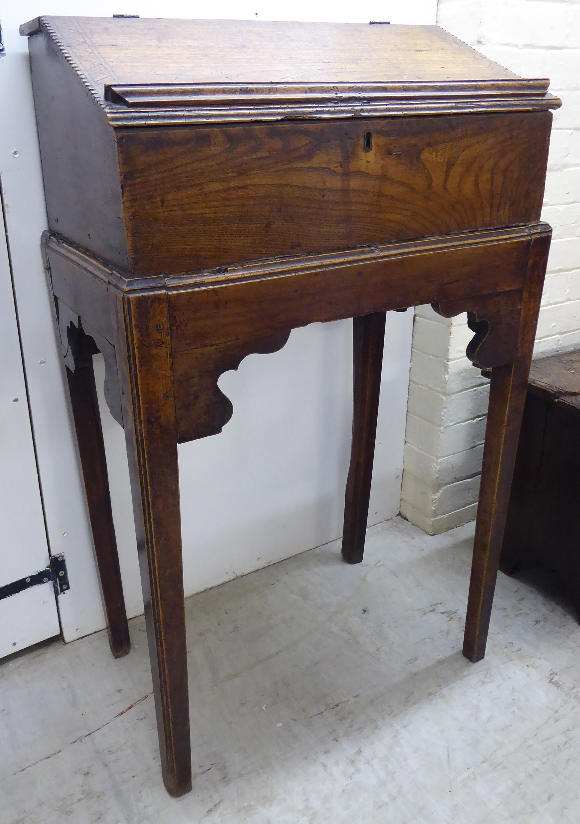 An early George III elm Bible box, on a stand with a hinged, sloping flap, raised on square, - Image 2 of 2