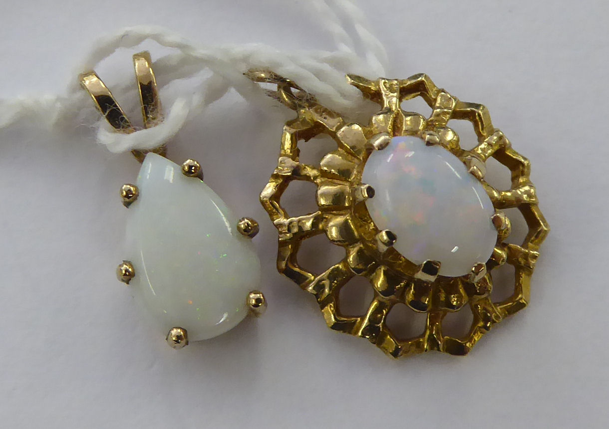 Two dissimilar 9ct gold and opal set pendants 11