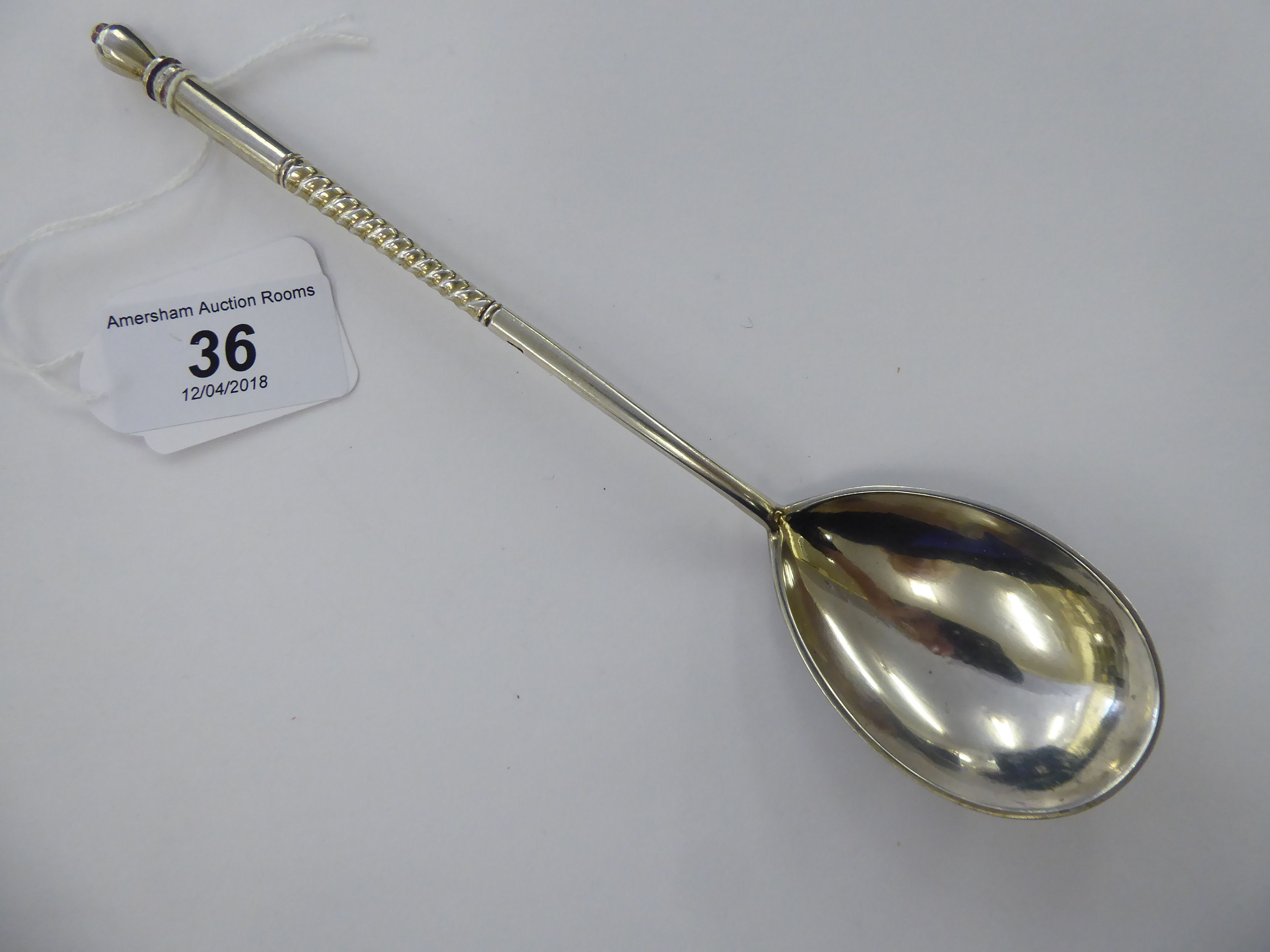 A 20thC Eastern European silver coloured metal presentation spoon,