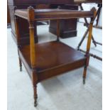 A modern mahogany finished two tier occasional table, raised on spindled supports,