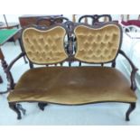 An Edwardian three piece carved mahogany framed salon suite, comprising an open arm settee,