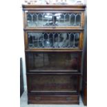 A mid 20thC Globe Wernicke matched oak and mahogany four section bookcase,