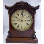 An early Victorian walnut cased bracket clock with a serpentine outlined top,