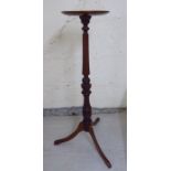 A Victorian style mahogany torchere, the turned top over a demi-reed carved column,
