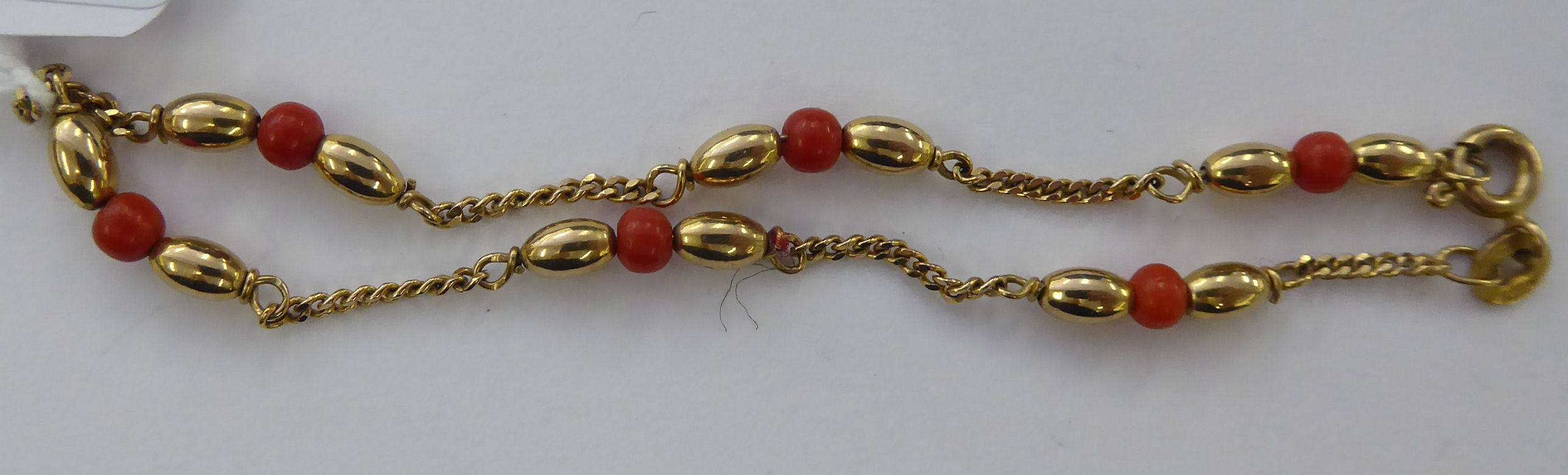 A 9ct gold and coral bead set bracelet 11