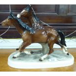 A Continental china model, two galloping horses,