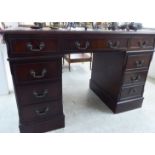 A modern mahogany finished nine drawer twin pedestal desk,