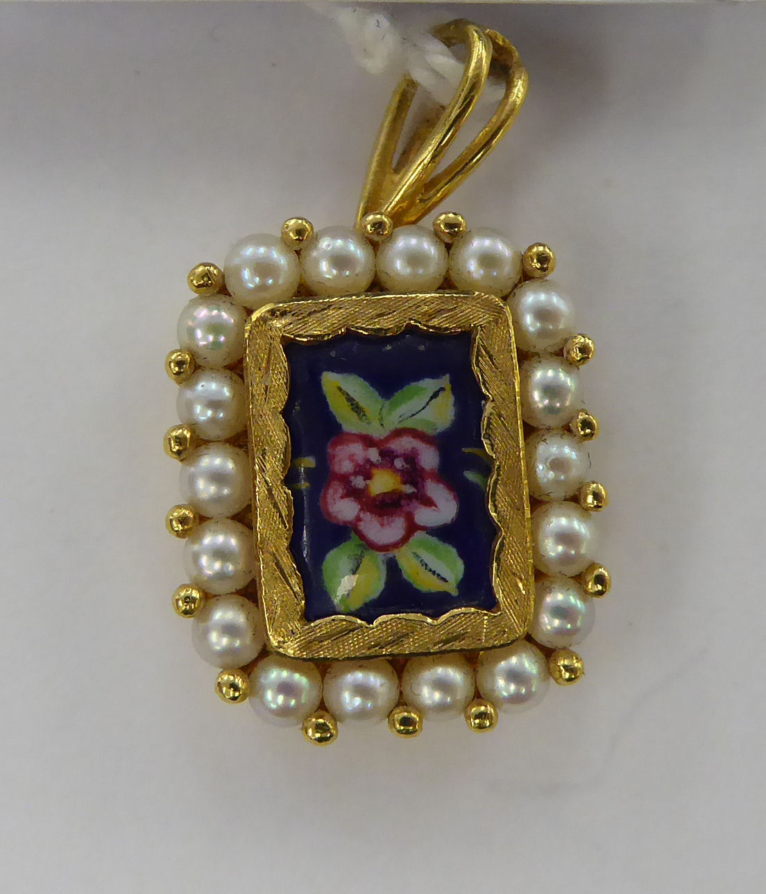 A gold coloured metal pendant,