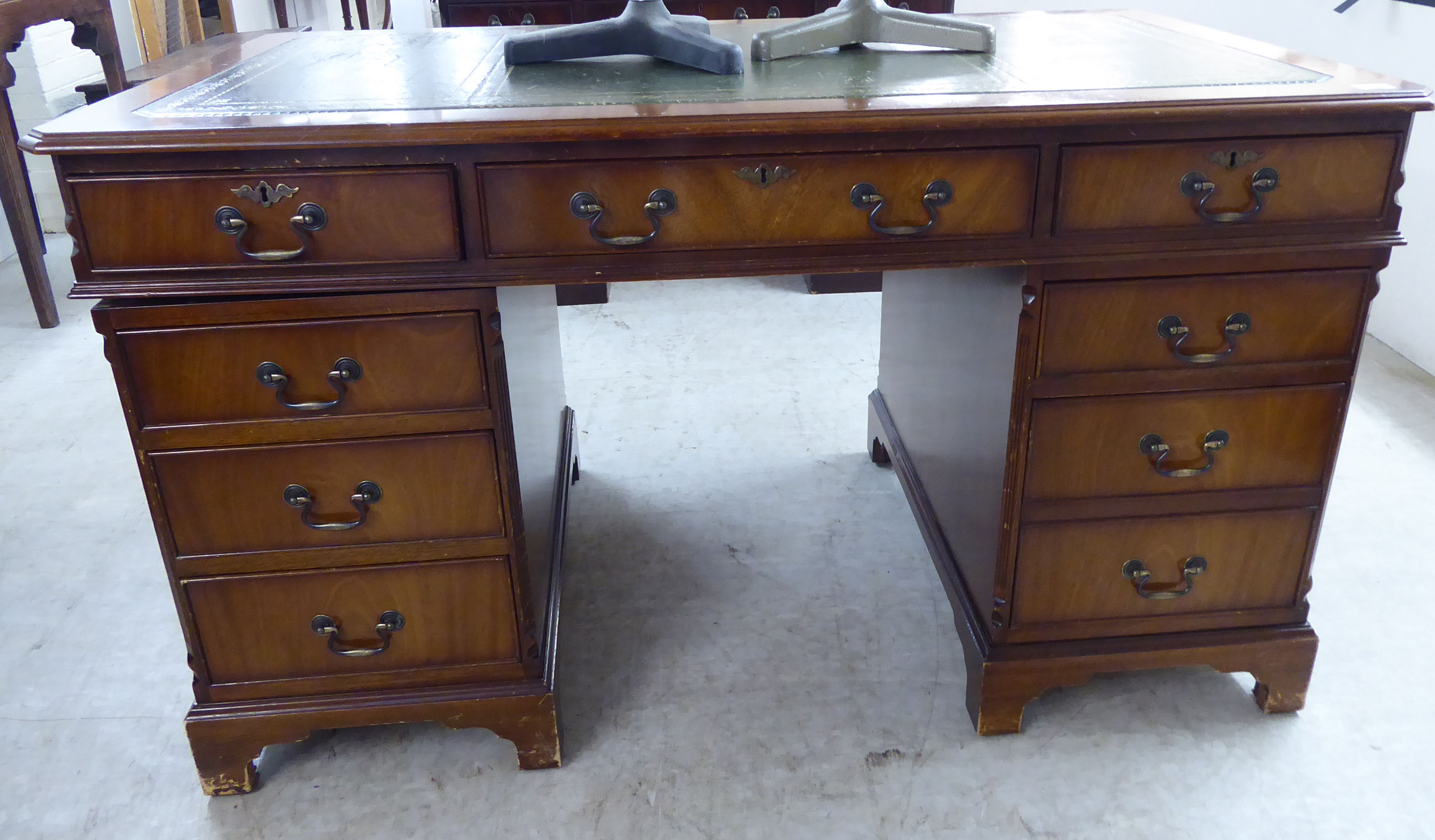 A modern mahogany finished nine drawer twin pedestal desk,