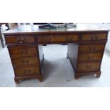 A modern mahogany finished nine drawer twin pedestal desk,