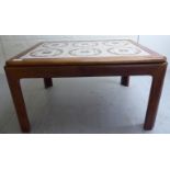 A 1960s teak coffee table, the top set with six geometrically patterned pottery tiles,