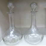 A pair of late 19thC facet cut glass bulbous bottle decanters with blown stoppers OS4