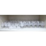 A suite of cut crystal pedestal drinking glasses of thistle design: to include wines,