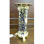 A Spode Copelands China lobed cylindrical vase with a flared rim, elevated on three claw feet,