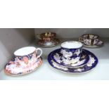 Four dissimilar Royal Crown Derby china tea cups and saucers,