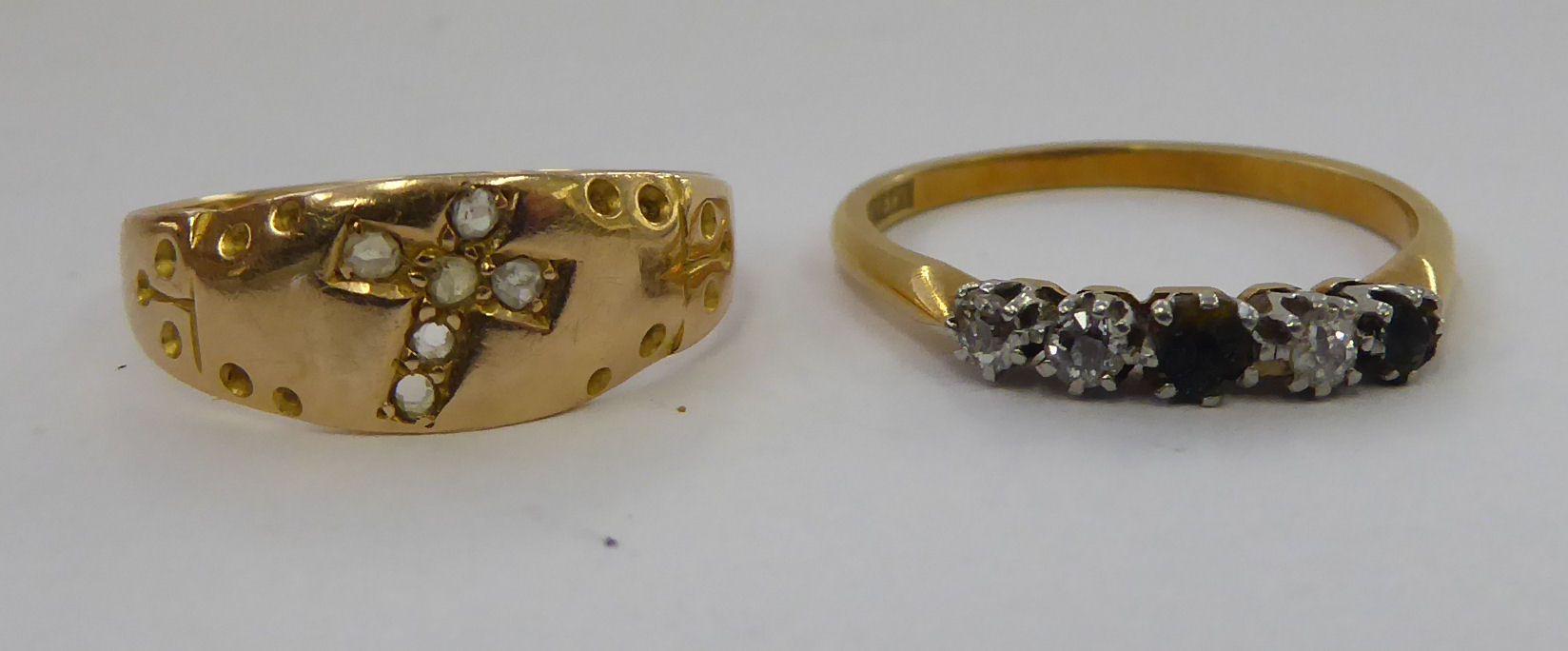 A 15ct diamond set gold ring, featuring a cross; and an 18ct gold ring,