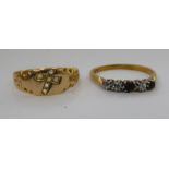 A 15ct diamond set gold ring, featuring a cross; and an 18ct gold ring,