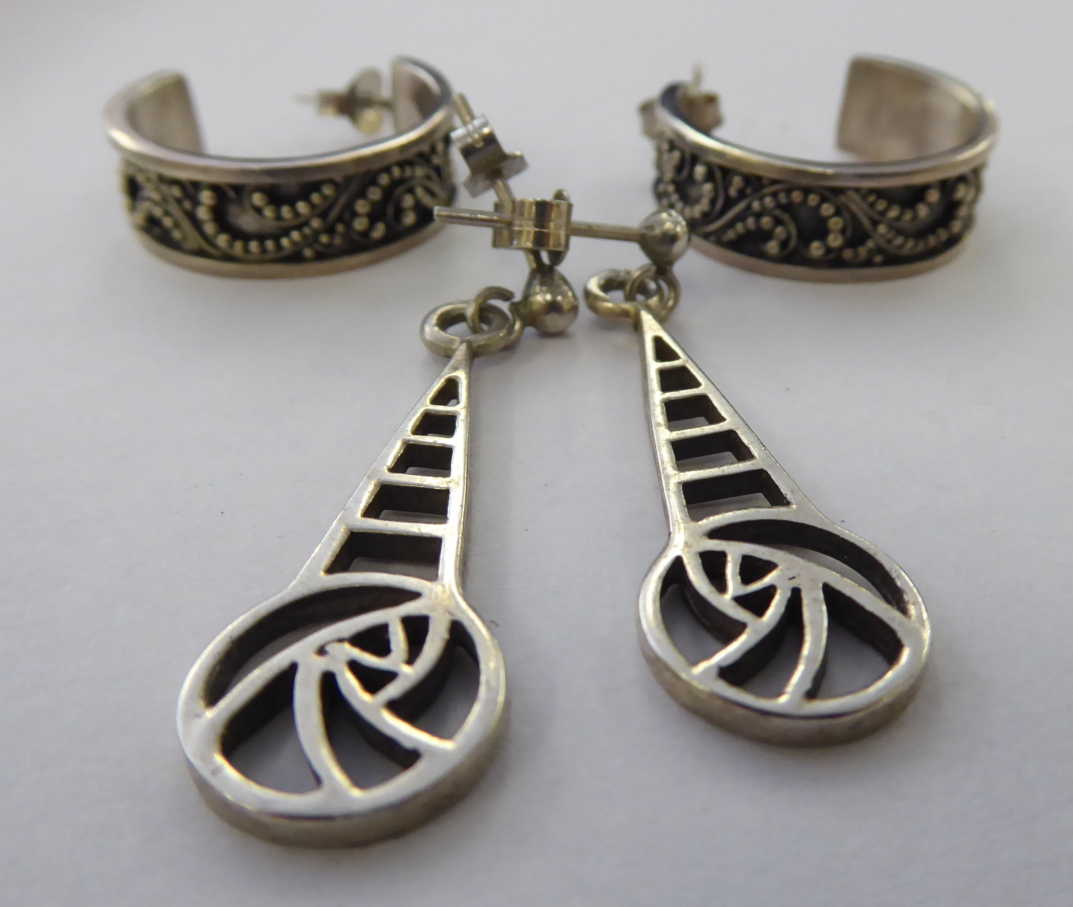 Two dissimilar pairs of silver earrings 11