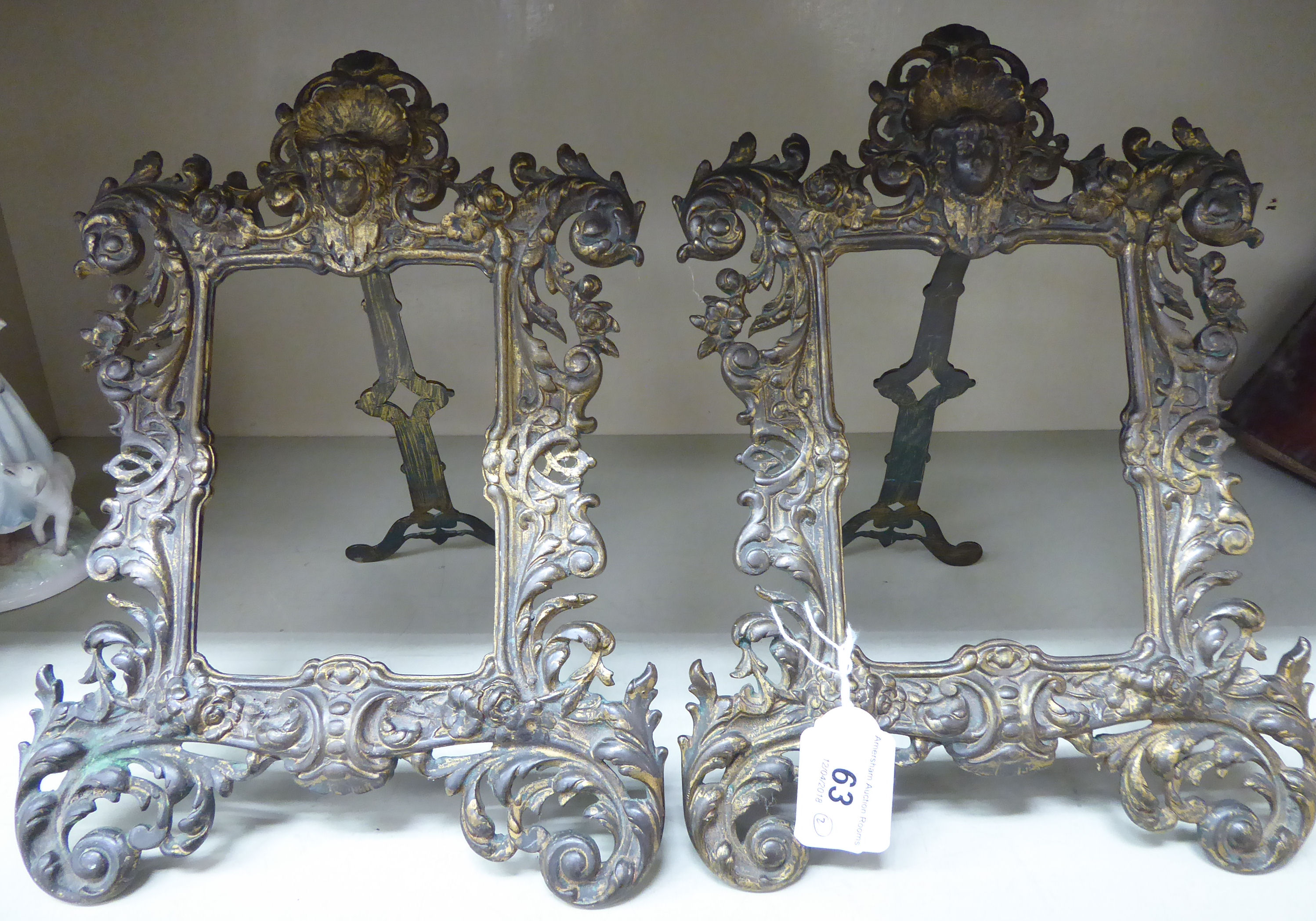 A pair of late Victorian gilded iron photograph frames,