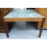 A 'retro' design teak framed coffee table with a tiled top,