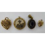 Four dissimilar 'antique' yellow metal lockets: to include one of heart design with floral engraved