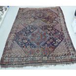 A Persian carpet decorated in panels and colours on a rust coloured ground 120'' x 85'' S