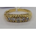 A gold coloured metal five stone diamond ring 11