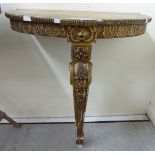 A late 19th/20thC moulded giltwood console table with a D-shaped top,