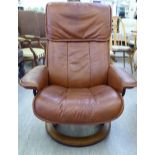 A modern mid brown hide upholstered recliner chair,