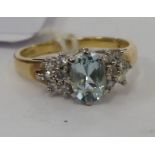 A 9ct gold claw set blue topaz and diamond ring 11