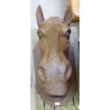 An unpainted cast iron horses head,