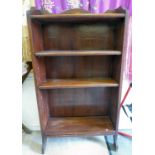 An Edwardian mahogany open front bookcase with a marquetry shell motif on the galleried upstand,